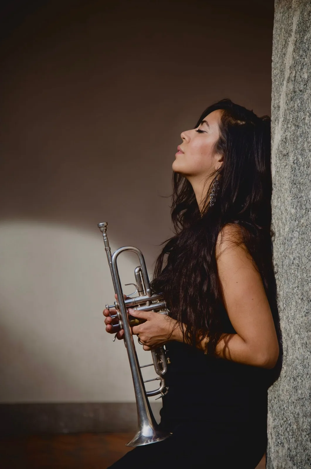 Maria Valencia concert portrait with trumpet